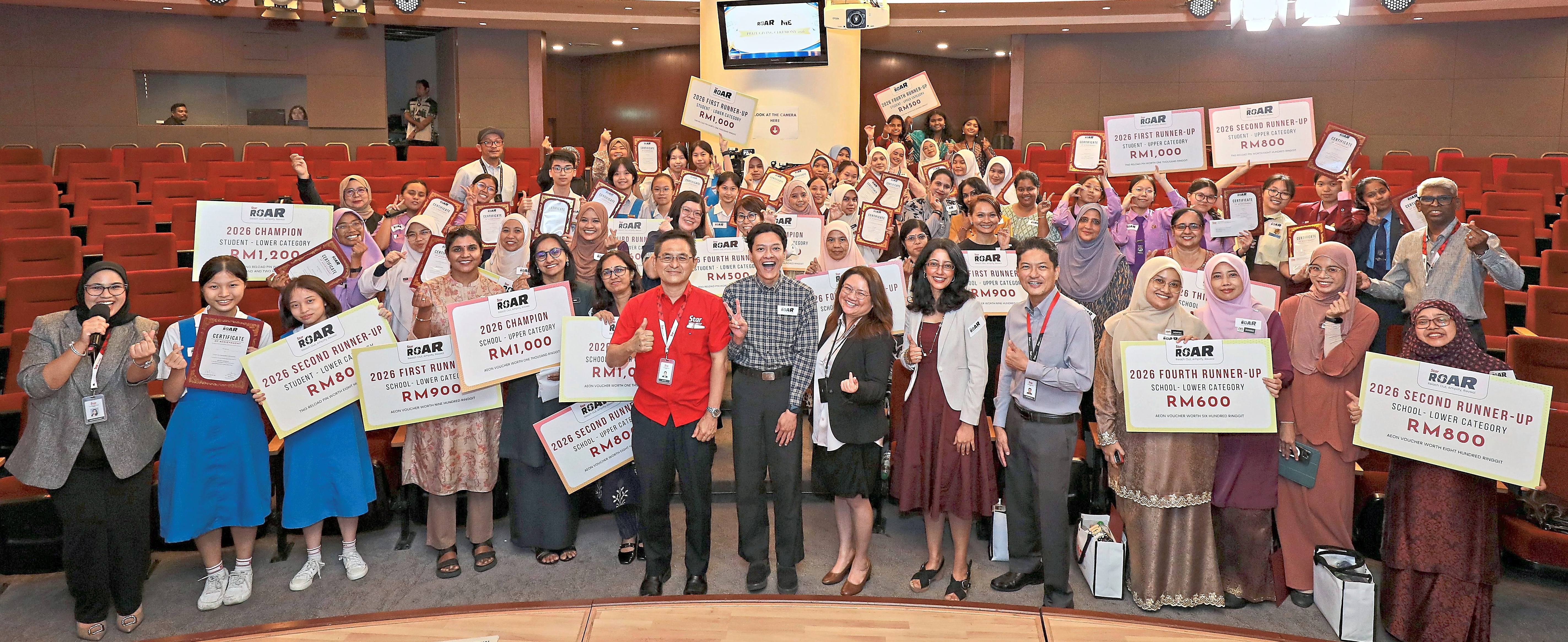 StarROAR 2026 award recipients and organisers posing together in the auditorium