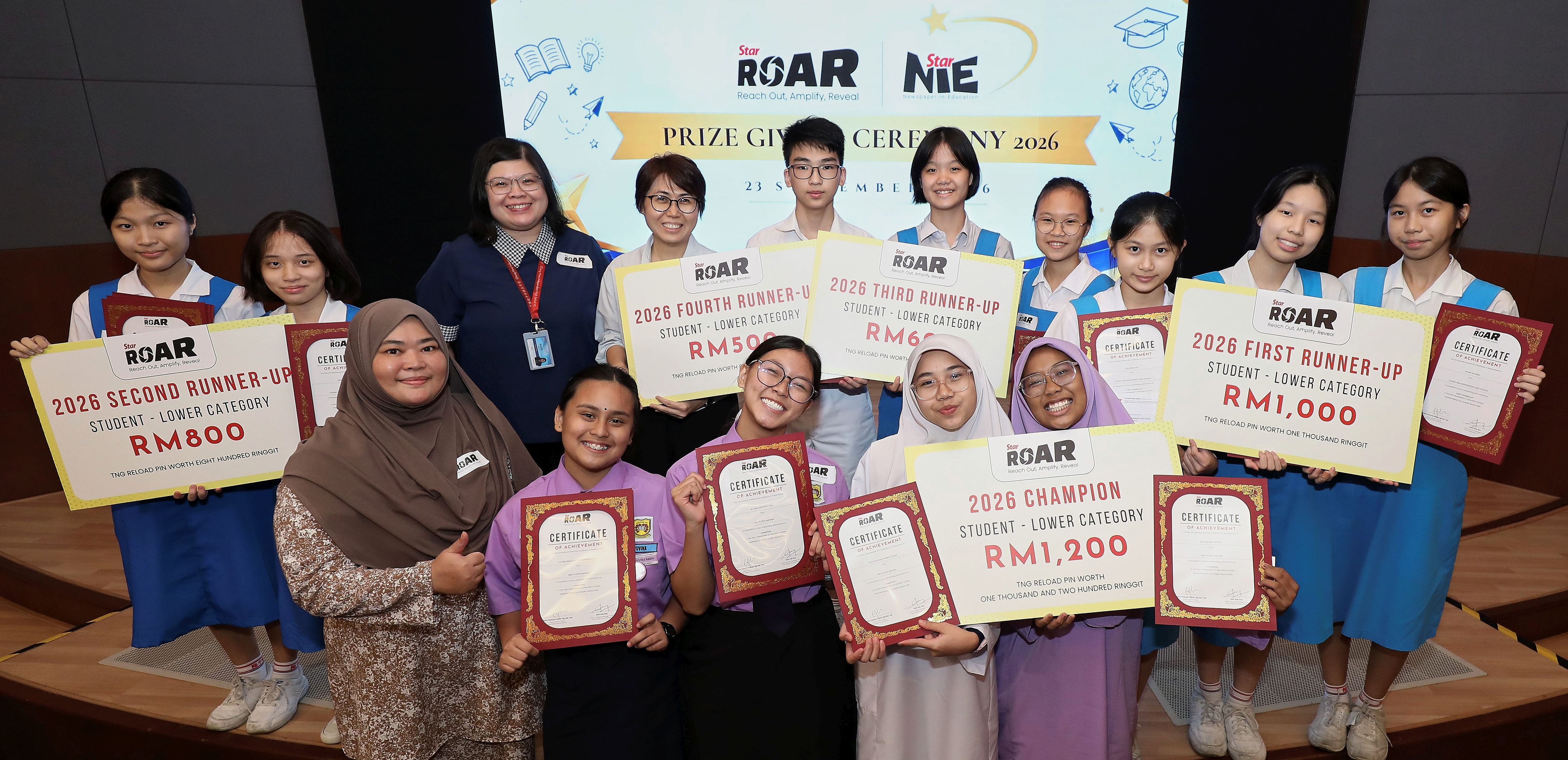 StarROAR 2026 prize recipients displaying their certificates and awards